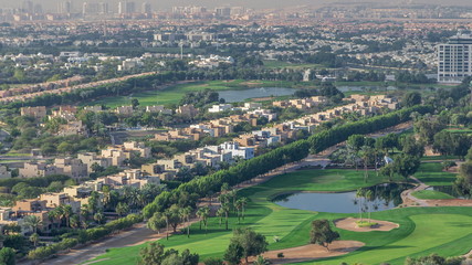 Aerial view to villas and houses with Golf course with green lawn and lakes timelapse