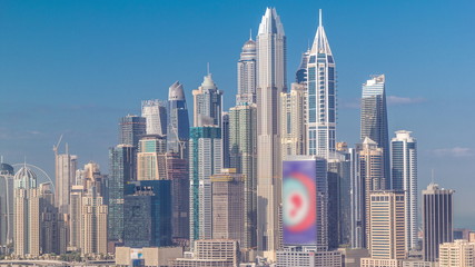 Obraz premium Dubai Marina skyscrapers and golf course morning timelapse, Dubai, United Arab Emirates