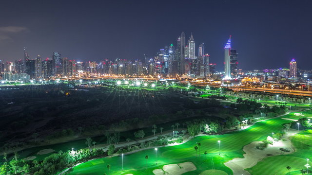 Dubai Marina skyscrapers and golf course all night timelapse, Dubai, United Arab Emirates