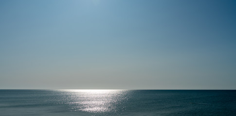 Fototapeta na wymiar glare on the blue sea, seascape as background