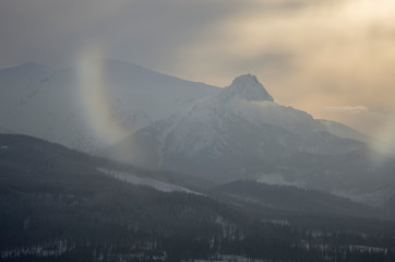 A warm light of a sunset in winter mountains.