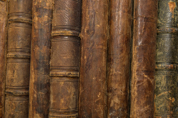 a stack of old vintage books in a library