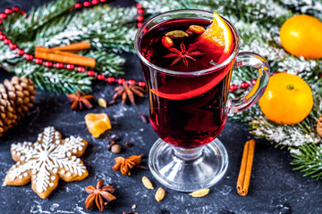 Christmas mulled wine with spices in cup on dark background