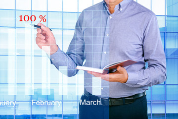 Businessman using virtual screen for  analyzing sales data and economic growth graph chart....