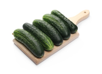 Cucumbers on wooden chopping board isolated on white background