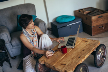 woman browsing online on her laptop at her home