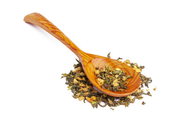 Dried tea on a wooden spoon, isolated on white