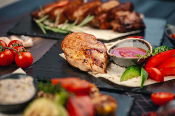 Marinated grilled healthy chicken breasts cooked on a summer BBQ