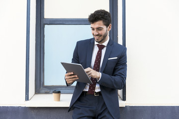 Front view lawyer looking at his tablet