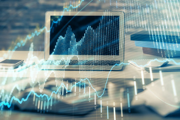 Financial graph colorful drawing and table with computer on background. Multi exposure. Concept of international markets.