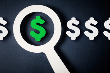 Checking finance with magnifying glass