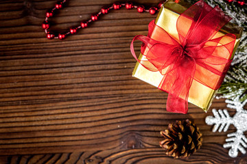 gifts boxes with fir branches on wooden background top view