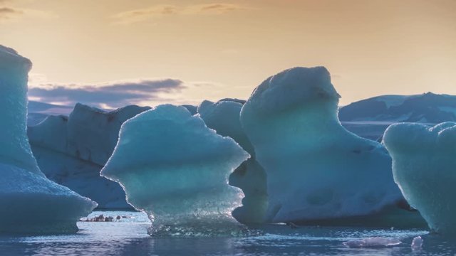Iceberg chunks in glacier bay at sunset