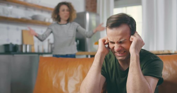 Annoyed husband tired of wife lecturing and arguing