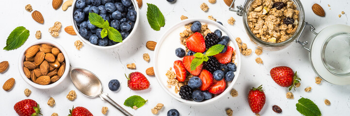 Greek yogurt granola with fresh berries on white table.
