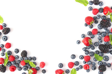 wild berries and mint leaves on a white background top view. blueberries, raspberries,...
