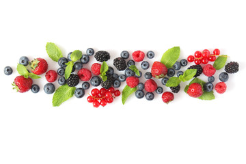 wild berries and mint leaves on a white background top view. blueberries, raspberries,...