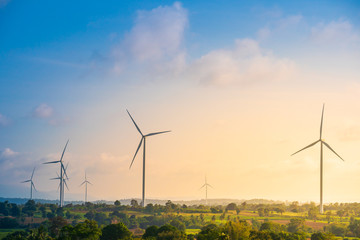 Green energy concept, eco power. Wind turbine located along the hill with the wind blowing all the...