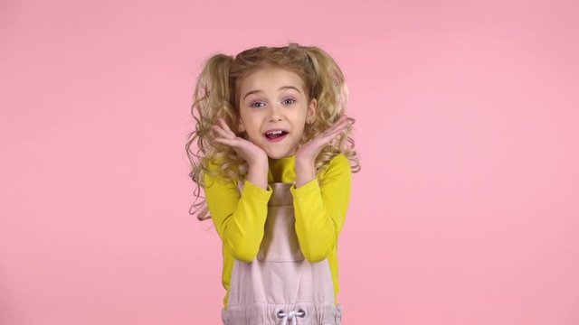 Little girl is very happy and clapping her hands. Slow motion