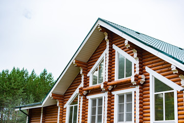 Closeup view of corner of wooden house made of natural logs - wooden construction background