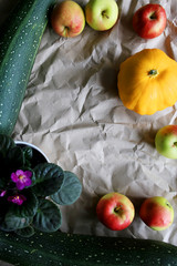 Autumn background with zucchini, apples, patisson. Place for text. 