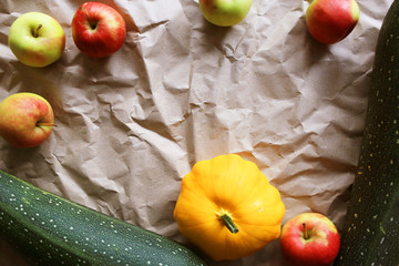 Autumn background with zucchini, apples, patisson. Place for text. 