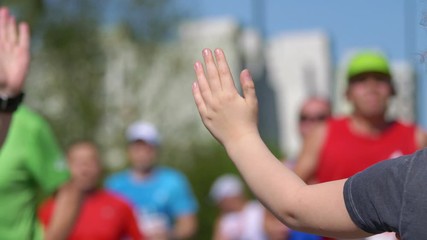Giving runners high five in 4K slow motion 60fps