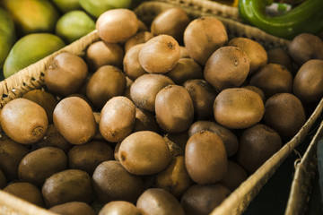 Exotic delicious organic kiwi in wicker basket at market