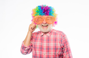 So much fun. happy birthday. corporate party. mature bearded man in colorful wig and party glasses. Crazy man in playful mood. anniversary holiday. happy man with beard. Celebration retirement