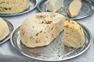 Different types of cheese on the table. Many cheese is sold at an agricultural fair. Natural home product.