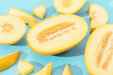 Naklejka na ściany i meble background with melon. sliced sweet and ripe melon on a blue background.