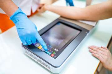Medical Procedure. Woman Scanning Veins With Vein Finder