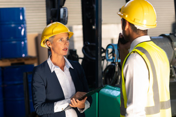 Female manager and male supervisor interacting with each other in warehouse