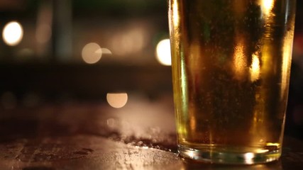 Pint glass of lager on pub table