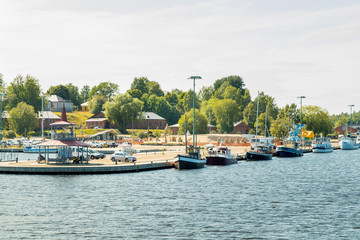 Fototapeta na wymiar Lappeenranta, Finland - August 7, 2019: Lappeenranta port with yachts and boats and sand castle on a sunny summer day