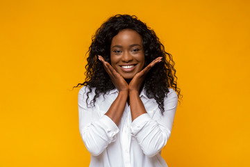 Emotional african american woman touching her cheeks