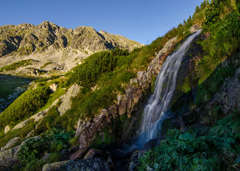 Fototapeta na wymiar Small waterfall in Retezat National Park, Carpathian Mountains, Romania