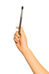 Female hand with eyeshadow or concealer brush