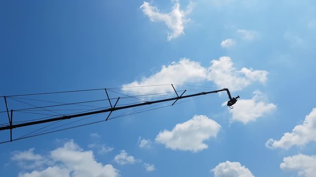 4K cinema production camera with crane in the blue sky
