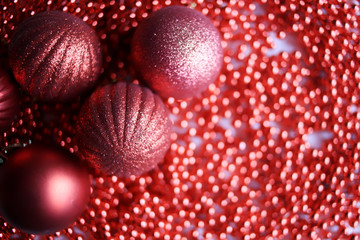 Defocused abstract red background, blurred bokeh. With a toy Christmas ball. Happy New Year