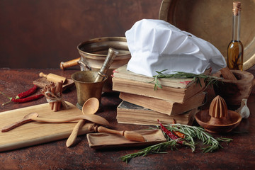 White chef's hat and old cookbooks.