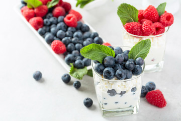 Cottage cheese with cream, raspberry and blueberry garnished with fresh mint.