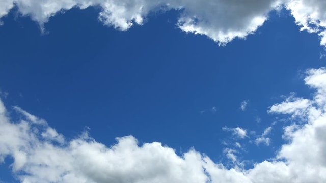 Blue sky with clouds and copyspace. Natural background, 4K