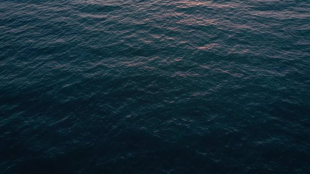 Aerial view of surface of the Atlantic Ocean on the background of a beautiful sunset