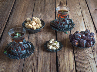 Tea with dates on a dark wooden table