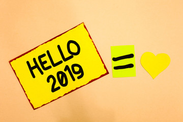 Conceptual hand writing showing Hello 2019. Business photo text Hoping for a greatness to happen for the coming new year Yellow paper reminder equal sign heart sending romantic feelings