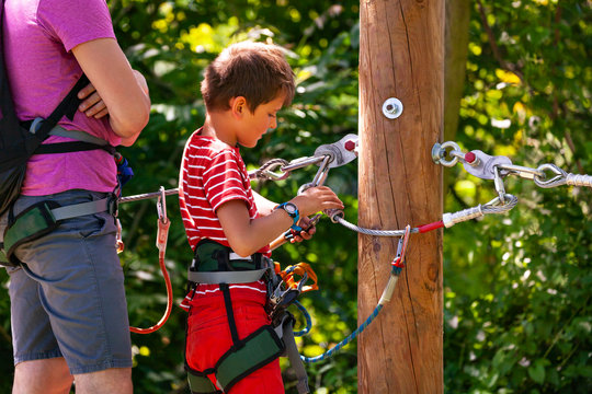 Instructor teach little boy use safety equipment - Powered by Adobe