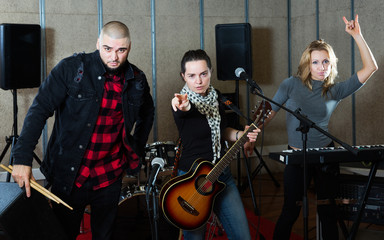 Fototapeta na wymiar group of rock musicians posing with instruments