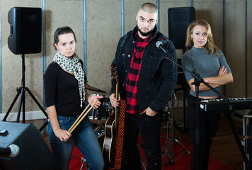 Fototapeta na wymiar expressive group of rock musicians posing with instruments