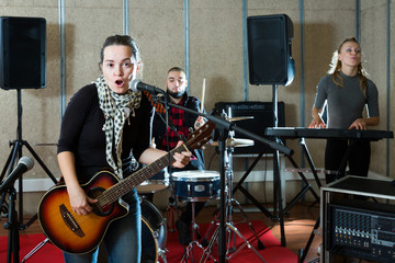 Fototapeta na wymiar Modern guitar player and singer with band